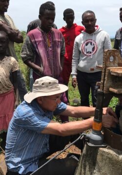 A WEFTA worker and local partners troubleshoot a groundwater well that provides water to Bachuma Hospital in West Omo Zone, Ethiopia.